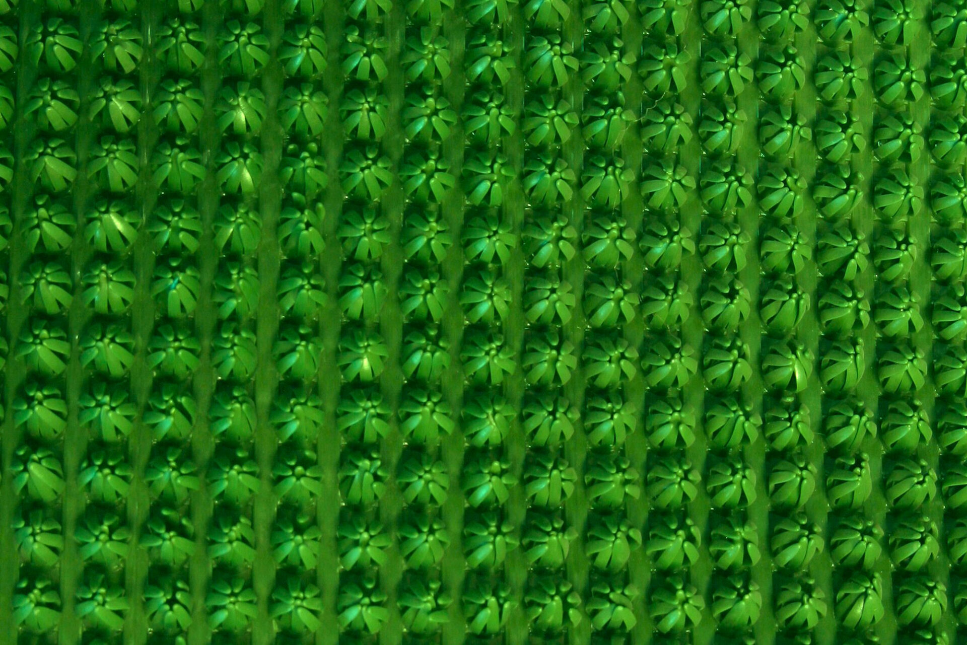 Roheline tekstuuriline taust korduvate mustritega.