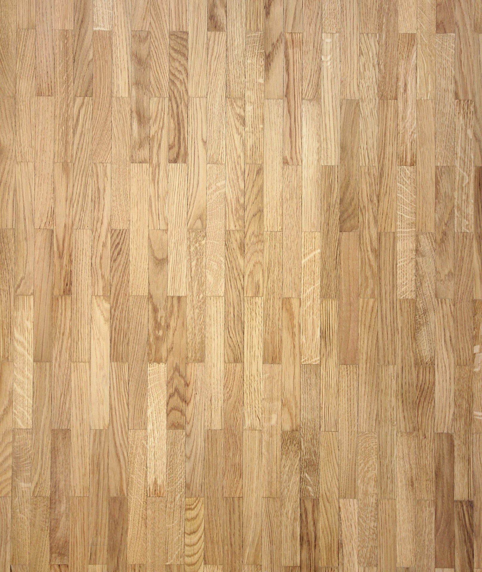 Puidust parketi muster helepruunides toonides.