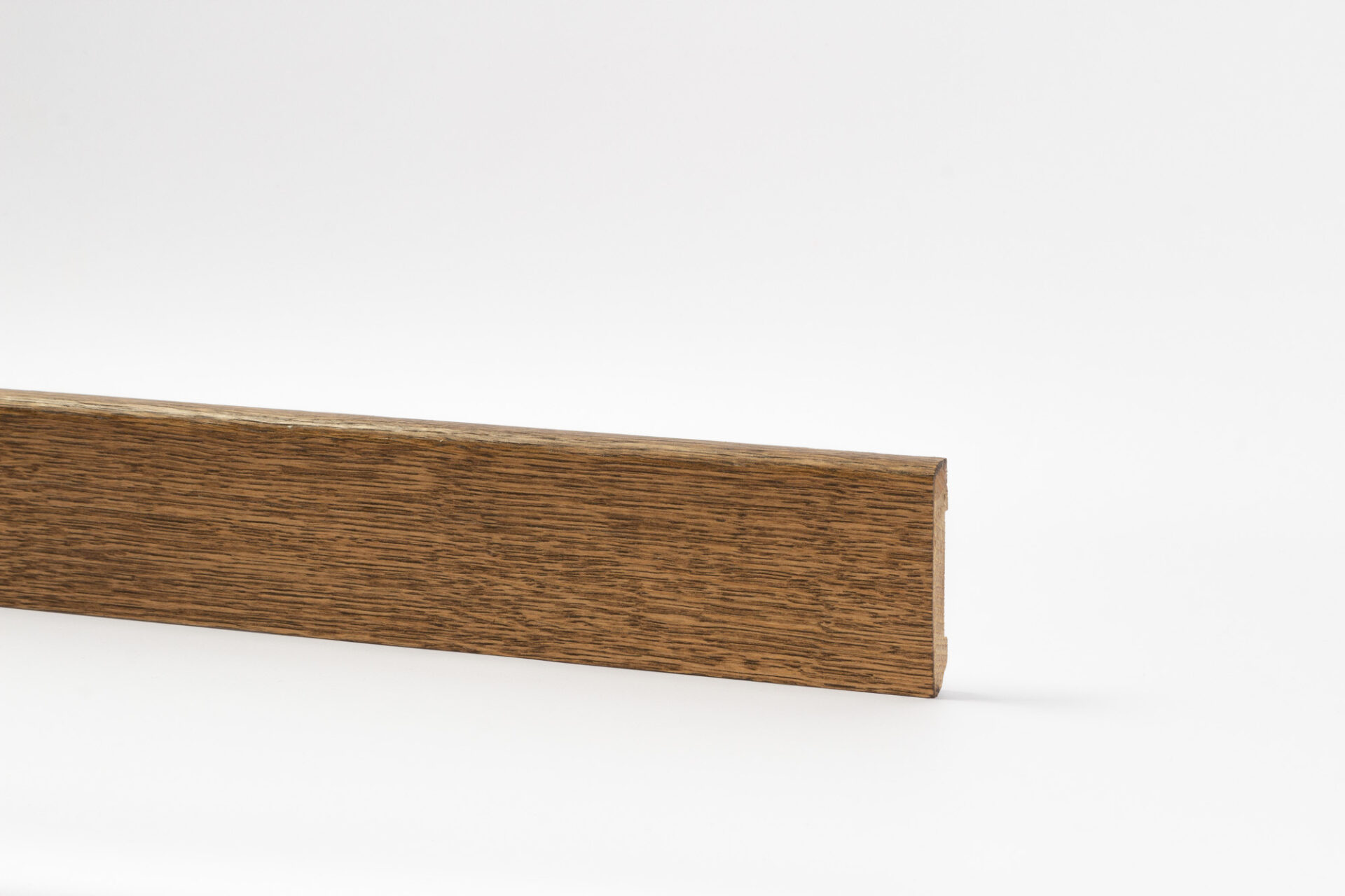 Puidust põrandaliist hele halli taustaga