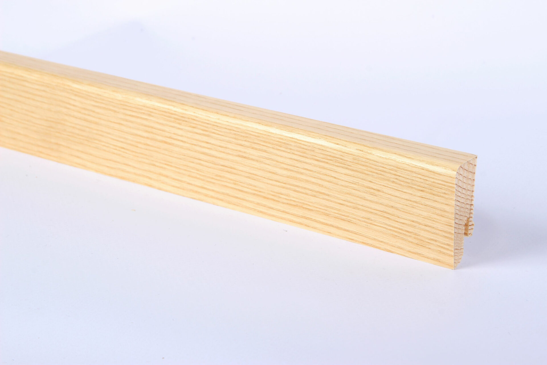 Puidust põrandaliist helepruuni tooni taustal.