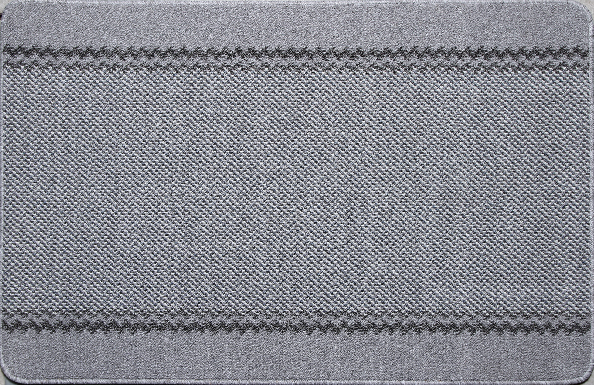 Hallikashalliline tekstiilvaip lähedalt vaadatuna tekstuuriga.